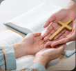 prays with bible and wooden cross